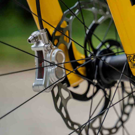 Comparison of worn vs new Shimano disc brake pads showing thickness difference