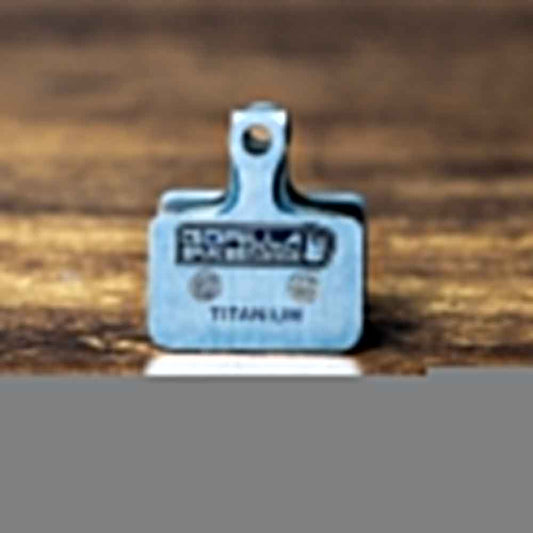 Gorilla Brakes Factory Racing titanium backplate disc brake pad for Shimano GRX, road, and gravel bikes.