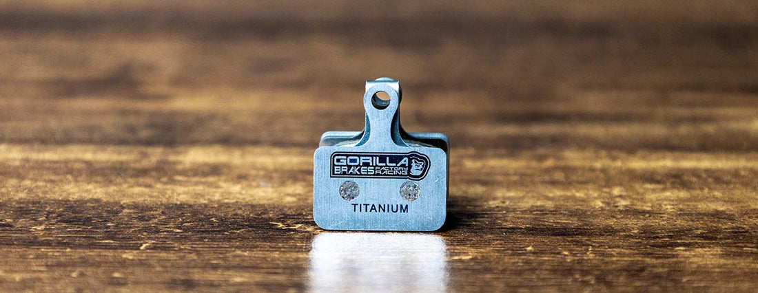Gorilla Brakes titanium-backed disc brake pad for Shimano road calipers on wood background for Shimano Ultegra, 105, Grx, Dura-ace disc brake calipers 