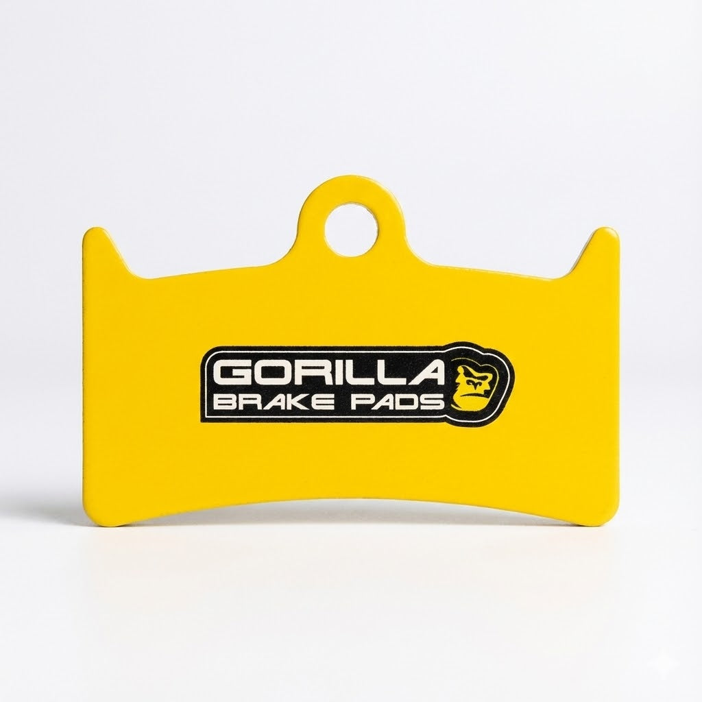 Yellow Gorilla Sintered Brake Pad backing plate designed for Hope V4 E-bikes, featuring the Gorilla Brake Pads logo and a central mounting eyelet.
