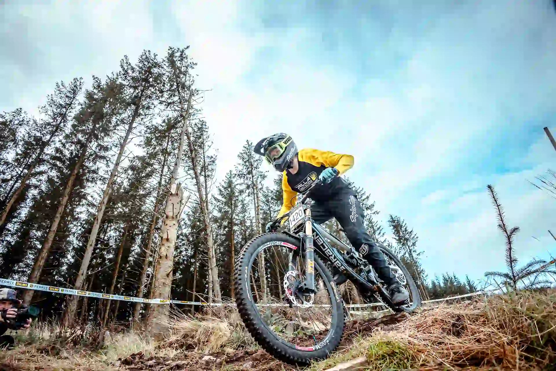 Corban, Gorilla Brakes team rider, using Factory Racing Enduro Pro Compounds on a mountain bike, showcasing high-performance disc brake pads for downhill racing.